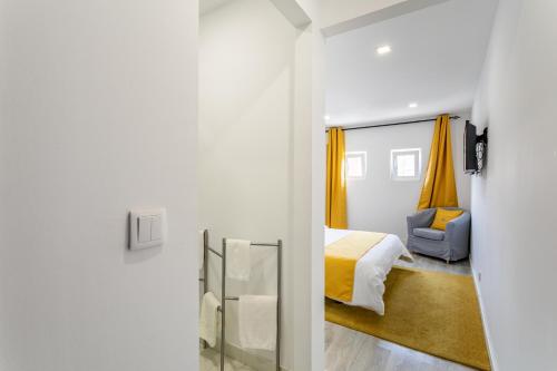 a bedroom with a bed and a mirror at Encarnação Home in Lisbon