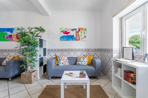 a living room with a couch and a table at Encarnação Home in Lisbon