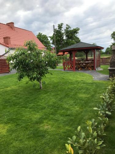 a gazebo with a picnic table in a yard at Agroturystyka "Zielone Zacisze" in Łagów