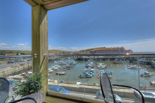 a view of a marina with boats in the water at Sandstones in West Bay