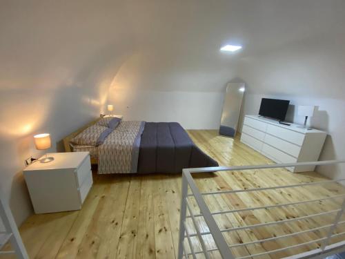 a small bedroom with a bed and a staircase at Pompei Civico 84 in Scafati