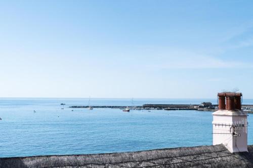 a view of a harbor with boats in the water at 2 Beach Way House in Lyme Regis