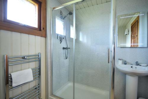 a bathroom with a shower and a sink at 10 Pinewood Retreat in Lyme Regis