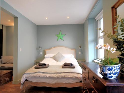 a bedroom with a bed with a star on the wall at Avocet in Lyme Regis