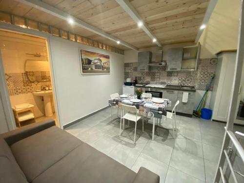 a kitchen and dining room with a table and chairs at Pompei Civico 84 in Scafati