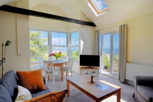 a living room with a couch and a table at Bay View in Lyme Regis