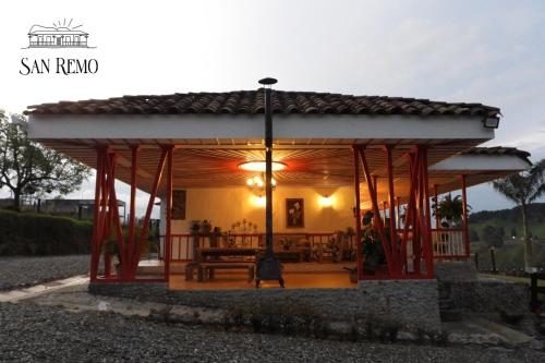 a gazebo with a table and benches at Hotel Rural SAN REMO in Santa Rosa de Cabal