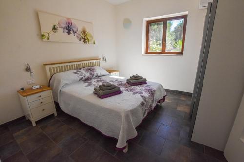 a bedroom with a bed with two towels on it at Masseria Giulio in Francavilla Fontana