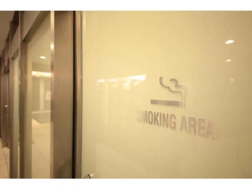 a glass door with a smokinghazard sign on it at R&B HOTEL HACHIOJI - Vacation STAY 38830v in Hachioji