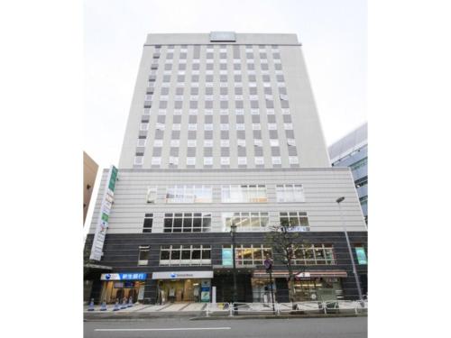 a tall white building on a city street at R&B HOTEL HACHIOJI - Vacation STAY 38818v in Hachioji