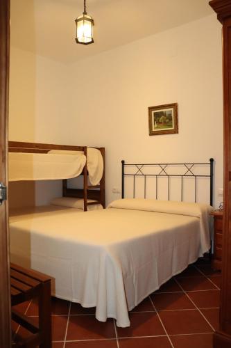 a bedroom with two beds in a room at Casa Almendro Rural in Guadalcanal