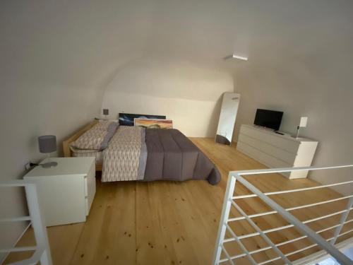 a large bedroom with a bed and a staircase at Pompei Civico 84 in Scafati