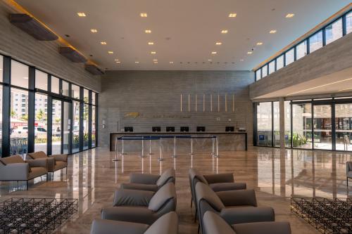 a lobby with chairs and a bar in a building at SALINAS PREMIUM - GAV Resorts in Salinópolis