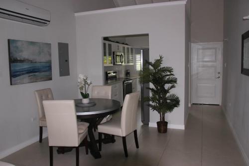a dining room with a table and white chairs at Cozy Getaway in Priory