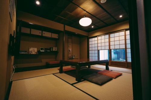 a room with a table in the middle of a room at Kyoto Machiya Tabijuku Kotoon - Vacation STAY 30119v in Kyoto