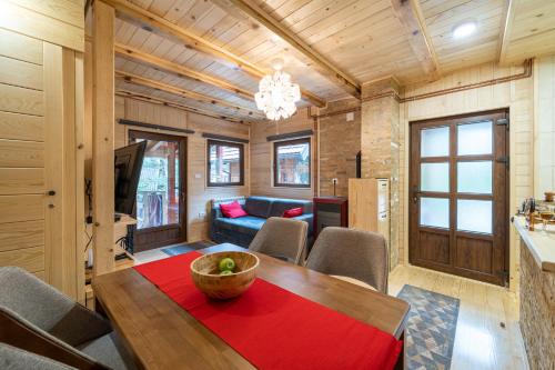 a living room with a table and a couch at Brvnara Ljubomir, planina Tara, Kaludjerske Bare in Kaludjerske Bare