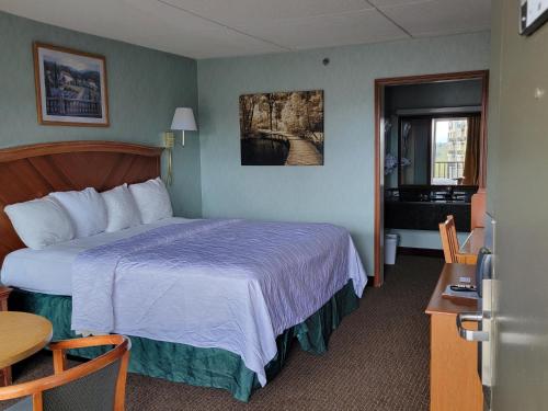 a hotel room with a bed and a table at Downtown Inn in Asheville