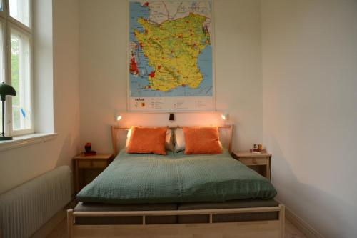 a bedroom with a bed with a map on the wall at Grevlunda skola in Vitaby