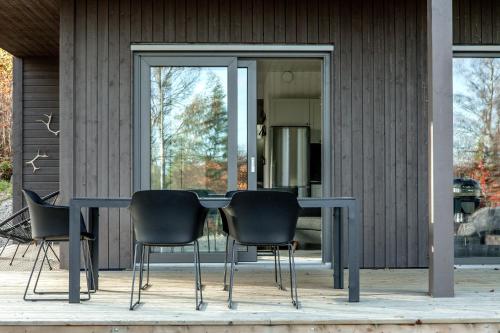 a table and four chairs in front of a house at Villabranten! Ski In - Ski Out, Bike In - Bike Out in Järvsö