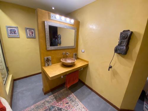 a bathroom with a sink and a mirror at Casarte Boutique Hotel in Playa del Carmen