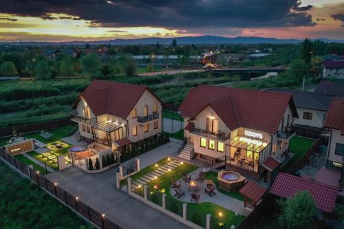 an aerial view of a house with a mansion at Roots Villa Redwood in Braşov