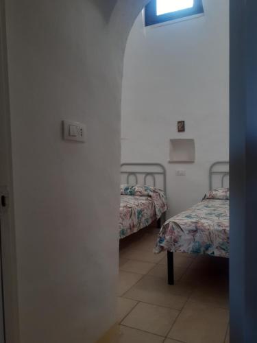 A bed or beds in a room at Trulli nonna Grazia-Aurora