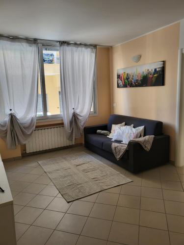 a living room with a blue couch and a window at King house in Sanremo