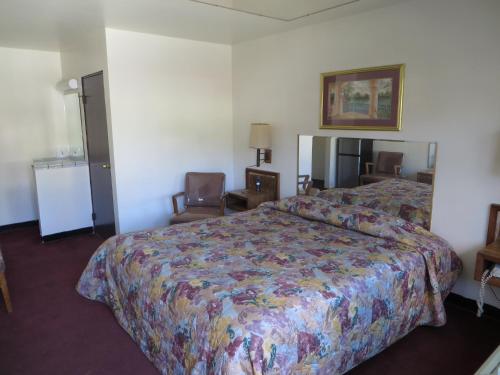 a hotel room with a bed with a colorful bedspread at Eagle Rock Motel in Los Angeles