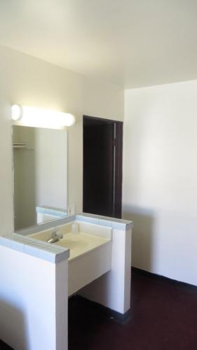 a bathroom with a sink and a mirror at Eagle Rock Motel in Los Angeles