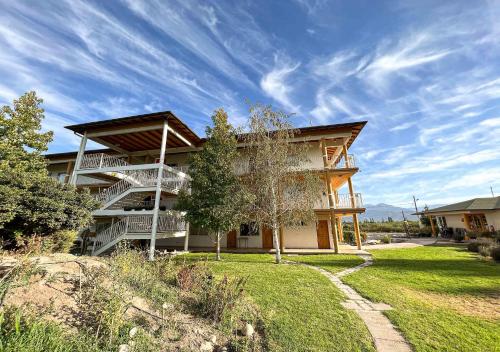 a large building with a lawn in front of it at Hotel El Almendro in Paine