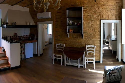 cocina y comedor con mesa y sillas en Casa Rosy nel centro del borgo di Patrignone, en Patrignone