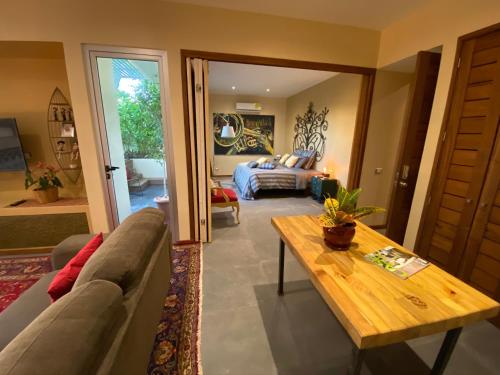 a living room with a couch and a table at Casarte Boutique Hotel in Playa del Carmen