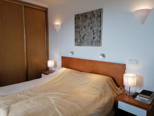 a bedroom with a large bed with two night stands at Sweden Apartment - Top Floor one bedroom with sea views - RS in Lagos