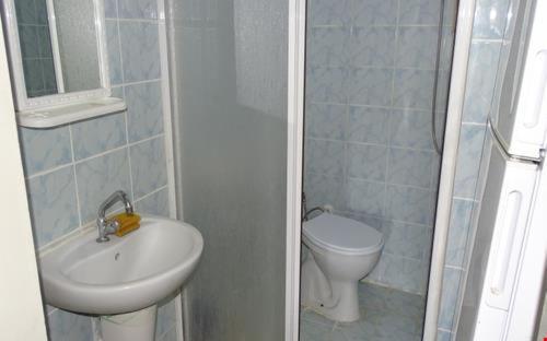 a small bathroom with a sink and a toilet at ERAY PANSİYON in Gokceada Town