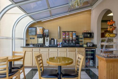 a restaurant with a table and chairs and a counter at Super 8 by Wyndham McDonough GA in McDonough