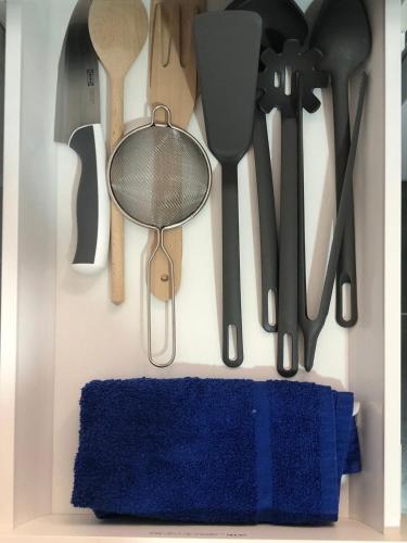 a bunch of kitchen utensils hanging on a wall at La Casita in Málaga