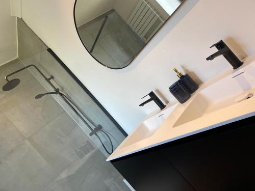 a bathroom with a sink and a mirror at Huis Louis in Kortessem
