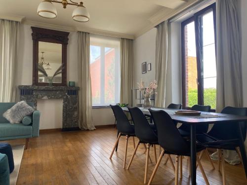 sala de estar con mesa de comedor y sillas en Huis Louis en Kortessem