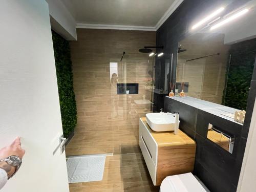 a bathroom with a sink and a toilet and a mirror at Azimuth Resort in Mamaia Nord