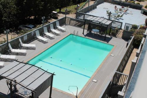 a large swimming pool with lounge chairs at Treehouse Condos - Branson in Branson