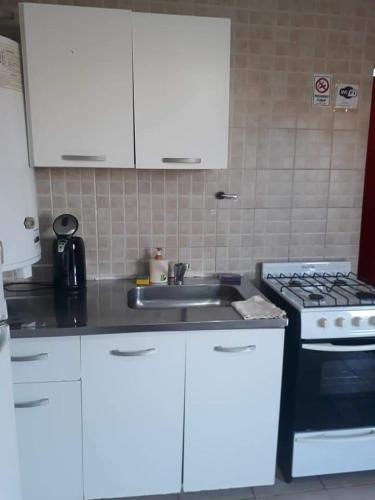 a kitchen with a sink and a stove at My House in El Calafate in El Calafate