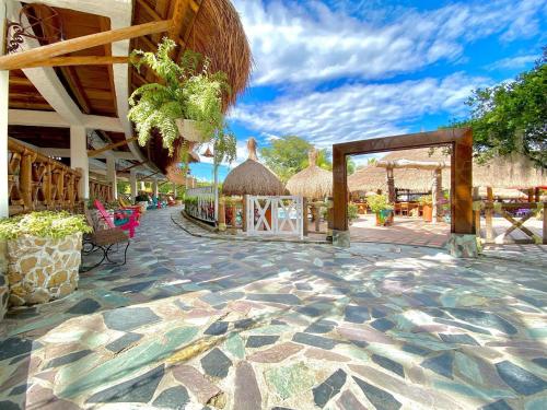 a resort with a stone floor and a pavilion at Hotel Campestre San Joaquin in Garzón