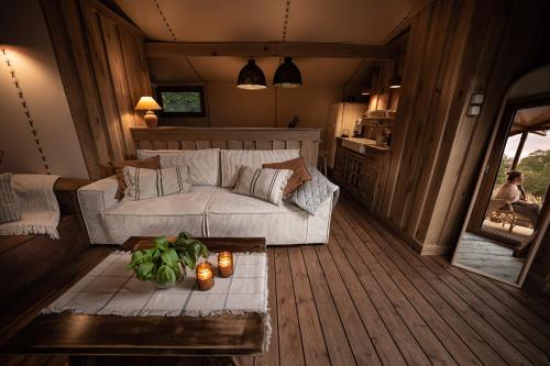 a living room with a couch and a table at Urzeka in Drzewce