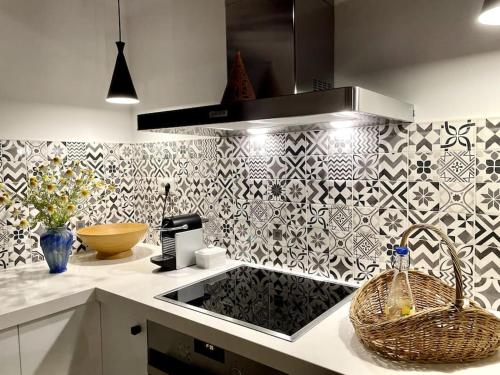 a kitchen with a counter with a sink and a stove at Katikies Savrani in Perivólia