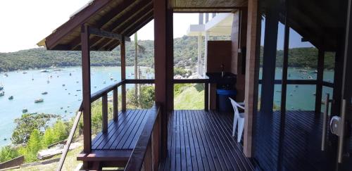 a balcony of a house with a view of the water at Marques Home in Porto Belo