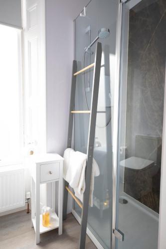 a bathroom with a shower with a glass door at Annandale Guest House in St. Andrews