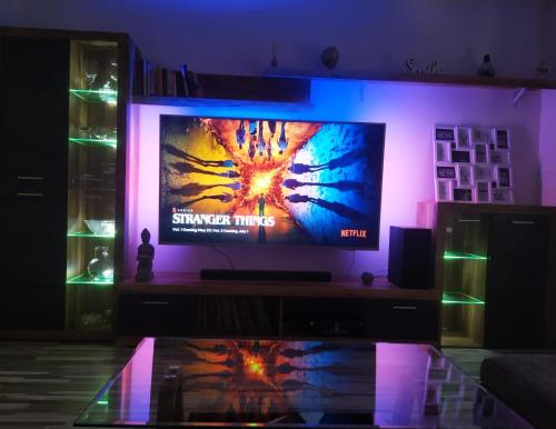 einen TV in einem Zimmer mit lila Licht in der Unterkunft Braavos Apartment 2 - Šibenik city center in Šibenik
