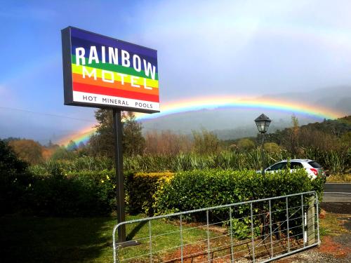 a rainbow in the sky with a sign and a rainbow at Rainbow Motel & Hot Pools in Turangi