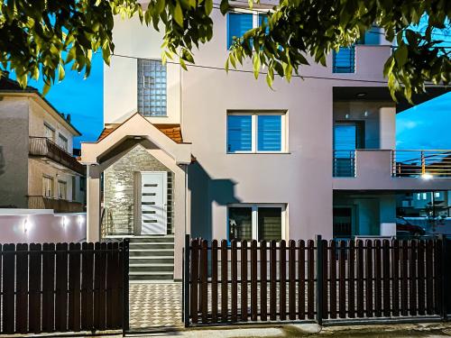 a house with a fence in front of it at PRILEP NEW BEST APARTMENTS in Prilep