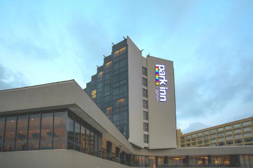 a building with a sign on the side of it at Park Inn by Radisson Libreville in Libreville